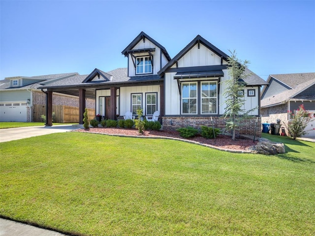 view of front facade featuring a garage, a front lawn, and covered porch