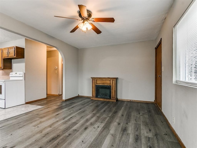 unfurnished living room with dark wood-type flooring and ceiling fan