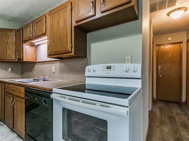 kitchen featuring sink, dishwasher, dark hardwood / wood-style flooring, decorative backsplash, and white electric stove