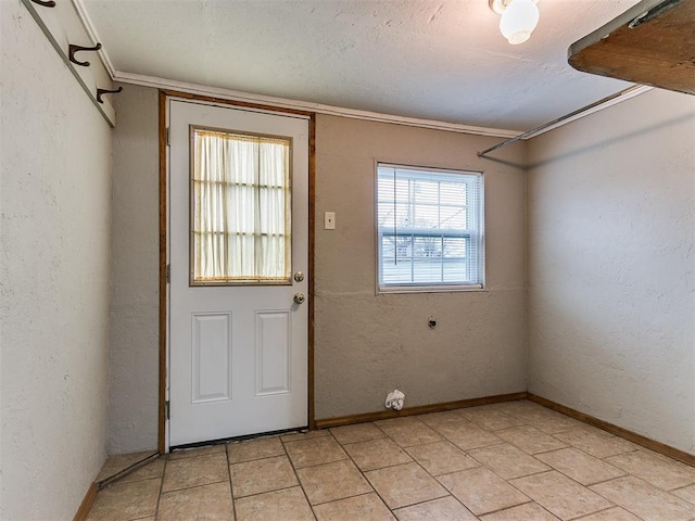 doorway to outside with ornamental molding and a textured ceiling