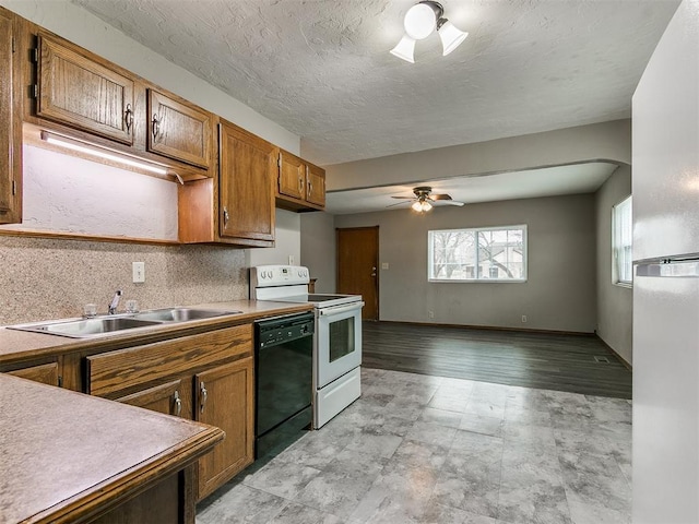 kitchen featuring sink, dishwasher, ceiling fan, electric range, and a textured ceiling