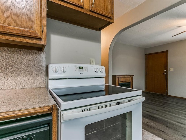 kitchen with tasteful backsplash, white electric range, and hardwood / wood-style floors