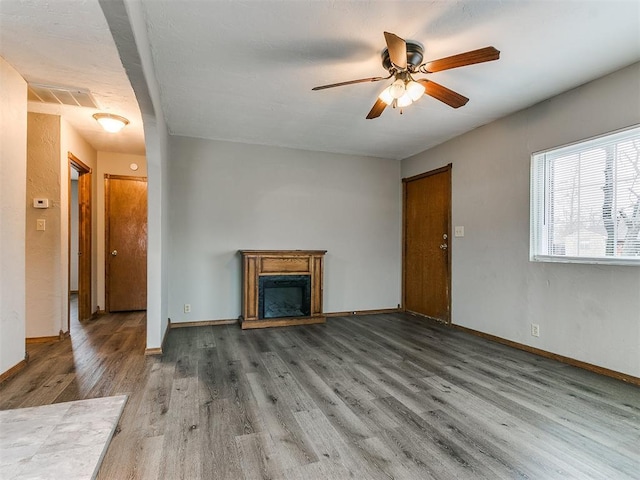 unfurnished living room with hardwood / wood-style floors and ceiling fan