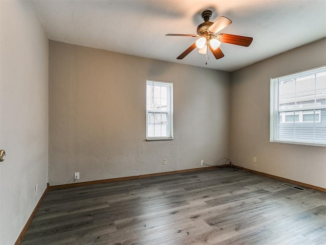 unfurnished room with hardwood / wood-style flooring and ceiling fan