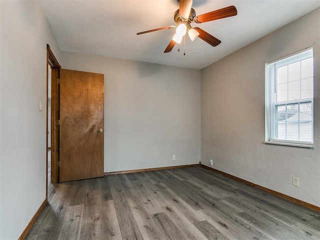 empty room with hardwood / wood-style flooring and ceiling fan