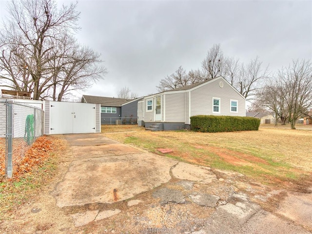 view of side of home with a yard