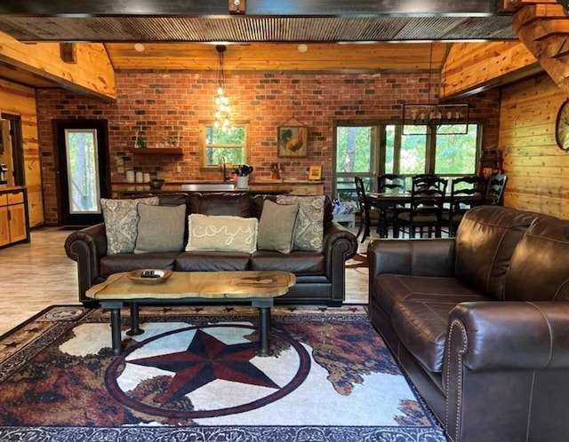 living room with hardwood / wood-style floors, wooden walls, and brick wall