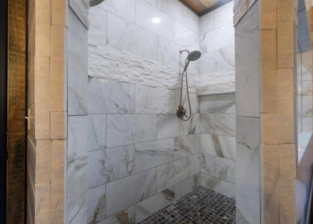 bathroom with a tile shower