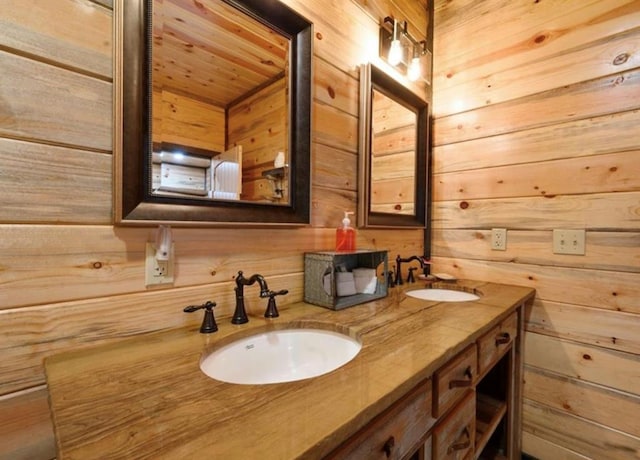 bathroom with vanity and wooden walls