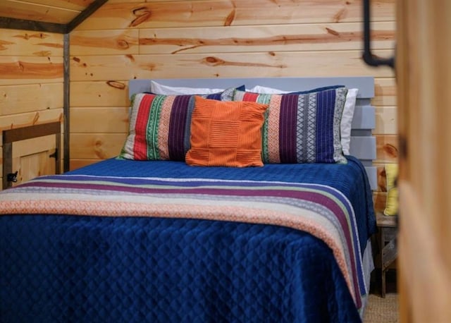 bedroom featuring wooden walls