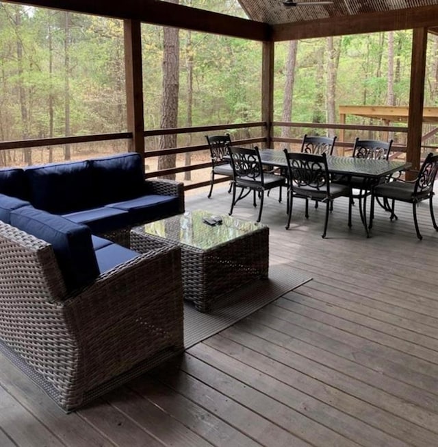 deck featuring ceiling fan and an outdoor living space