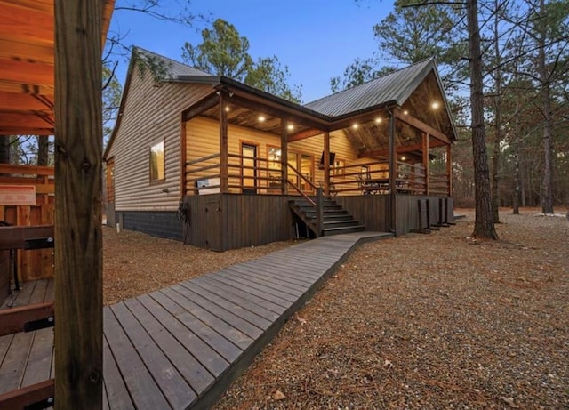 property exterior at dusk with a wooden deck