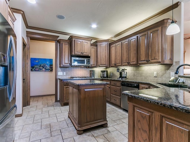 kitchen with tasteful backsplash, sink, dark stone counters, hanging light fixtures, and stainless steel appliances