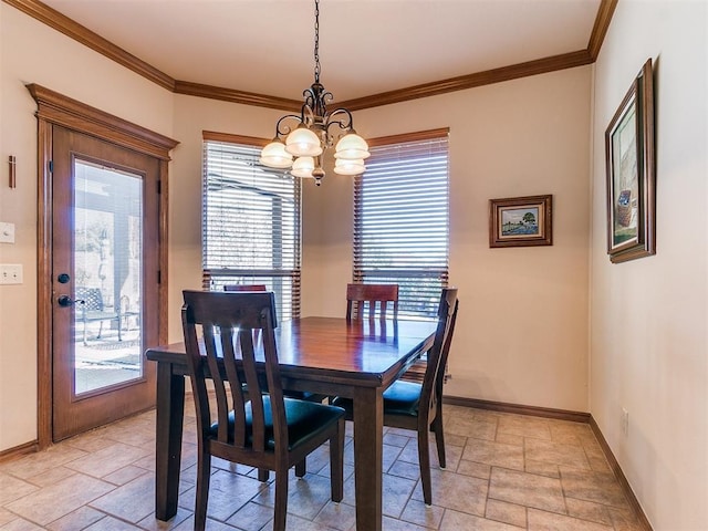 dining area featuring ornamental molding and a notable chandelier