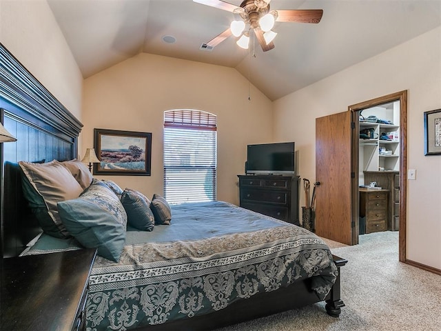 carpeted bedroom featuring vaulted ceiling, a spacious closet, ceiling fan, and a closet