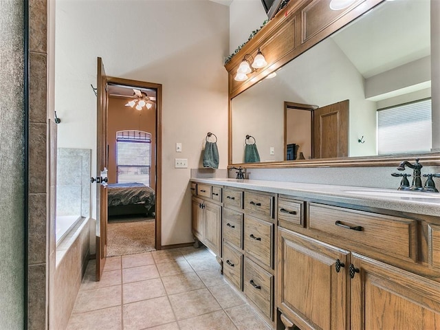 bathroom featuring a healthy amount of sunlight, tile patterned floors, and vanity