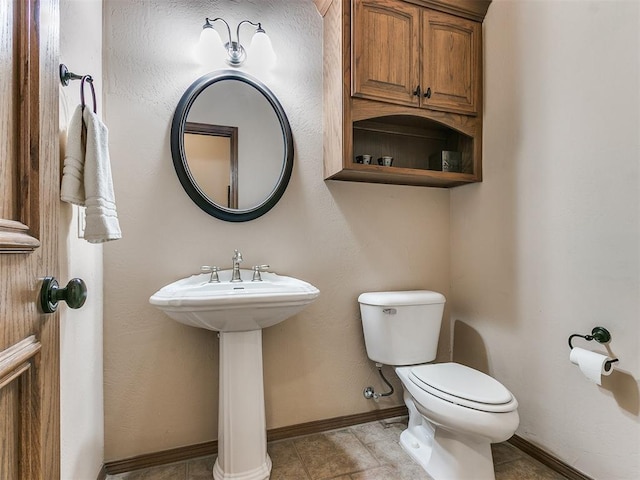 bathroom featuring tile patterned floors and toilet