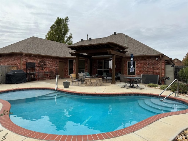 view of swimming pool featuring area for grilling, a patio area, and an outdoor fire pit