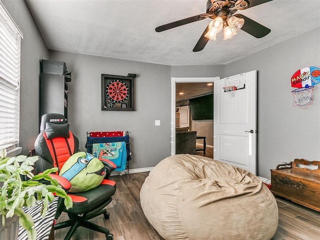 interior space featuring dark wood-type flooring, ceiling fan, and a textured ceiling