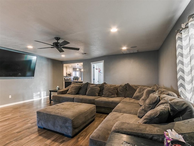 living room featuring hardwood / wood-style flooring and ceiling fan