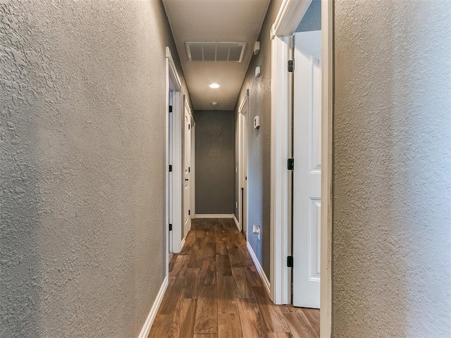 hallway featuring dark hardwood / wood-style flooring