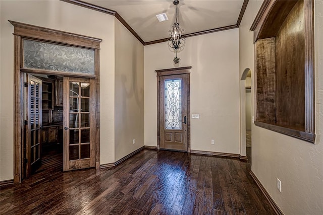 foyer featuring crown molding, dark hardwood / wood-style floors, and french doors