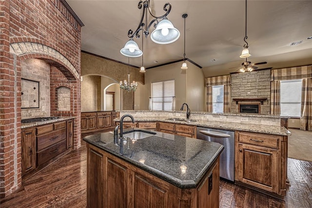 kitchen with pendant lighting, sink, a large island with sink, and appliances with stainless steel finishes