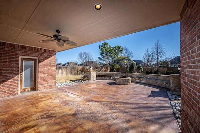 view of patio featuring ceiling fan and a fire pit