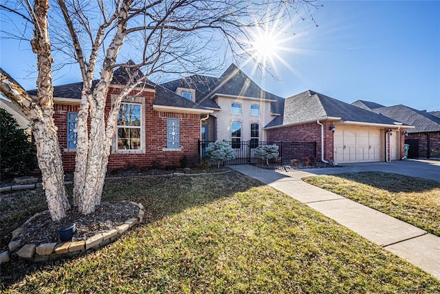 view of front of home featuring a garage and a front lawn