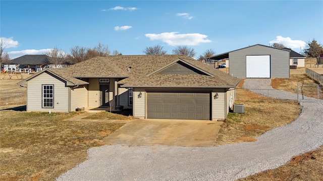 view of front of property with a garage and central AC