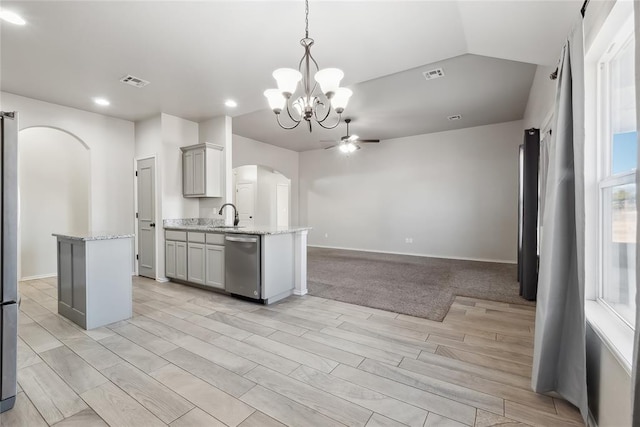 kitchen with gray cabinets, ceiling fan with notable chandelier, decorative light fixtures, dishwasher, and sink