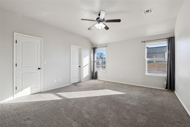 unfurnished bedroom featuring ceiling fan, lofted ceiling, and light carpet