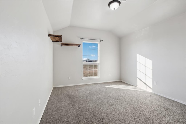 unfurnished room with lofted ceiling and carpet flooring