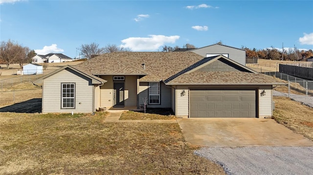 single story home with a garage and a front lawn