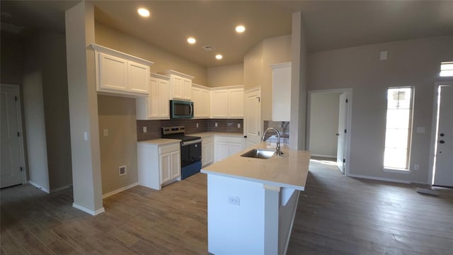 kitchen featuring sink, dark hardwood / wood-style floors, white cabinets, stainless steel range with electric cooktop, and decorative backsplash