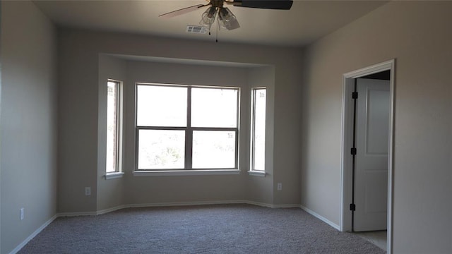 carpeted empty room featuring ceiling fan