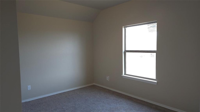 unfurnished room featuring vaulted ceiling and carpet floors