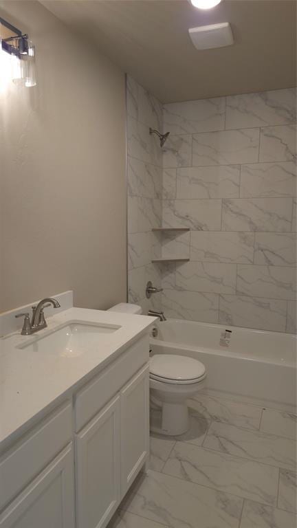 full bathroom with toilet, vanity, and tiled shower / bath