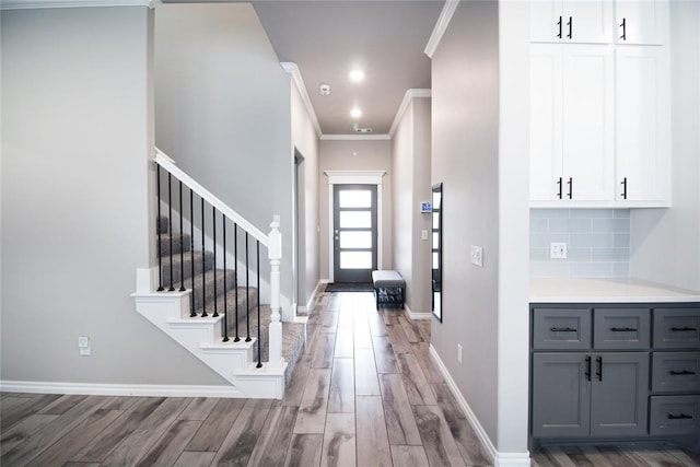 entrance foyer with crown molding and hardwood / wood-style flooring