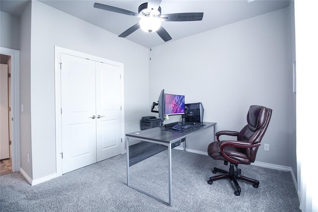 carpeted office space featuring ceiling fan