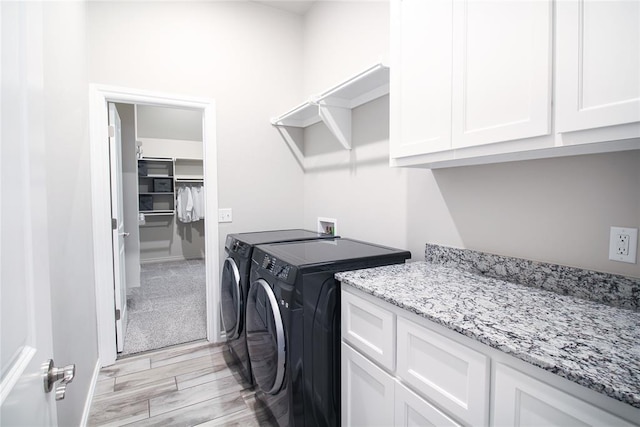 laundry area featuring cabinets and washing machine and dryer