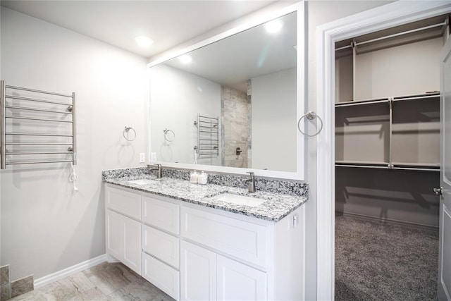 bathroom featuring radiator heating unit and vanity