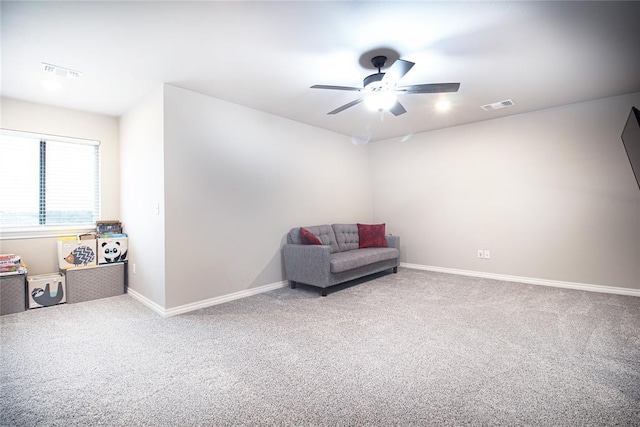 sitting room with carpet and ceiling fan