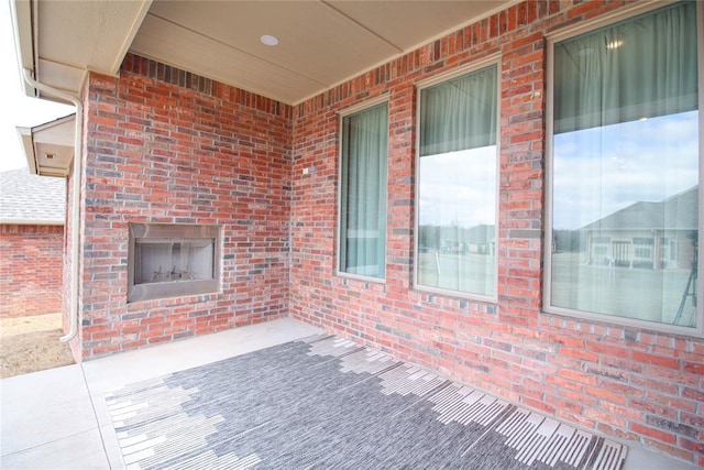 view of patio / terrace featuring an outdoor brick fireplace