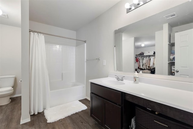 full bathroom with shower / bath combination with curtain, wood-type flooring, toilet, and vanity