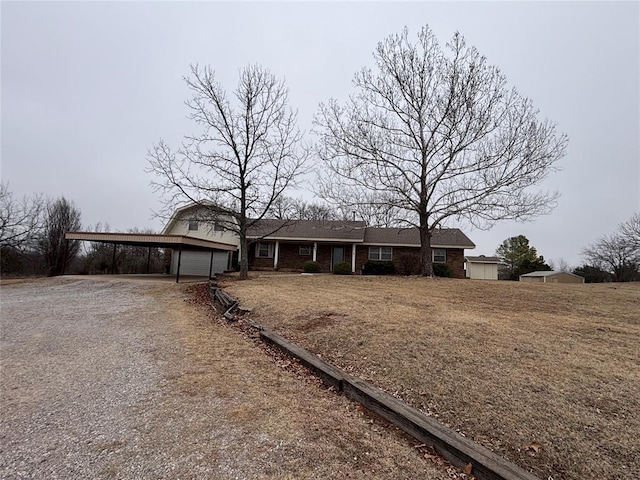 ranch-style house featuring a garage and a carport