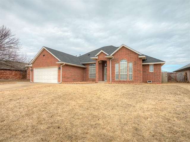 ranch-style home with a garage and a front lawn