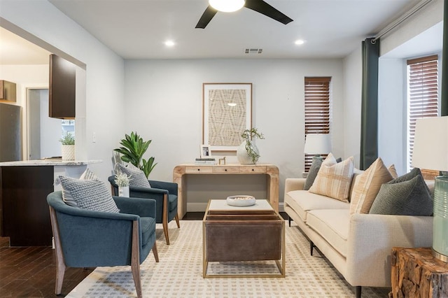 living room featuring ceiling fan and light hardwood / wood-style flooring