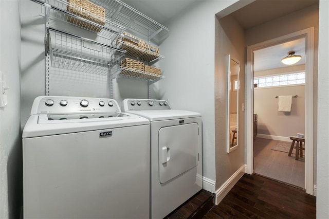 laundry area with dark hardwood / wood-style flooring and separate washer and dryer