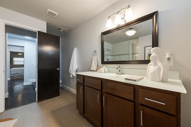 bathroom with vanity, toilet, and walk in shower